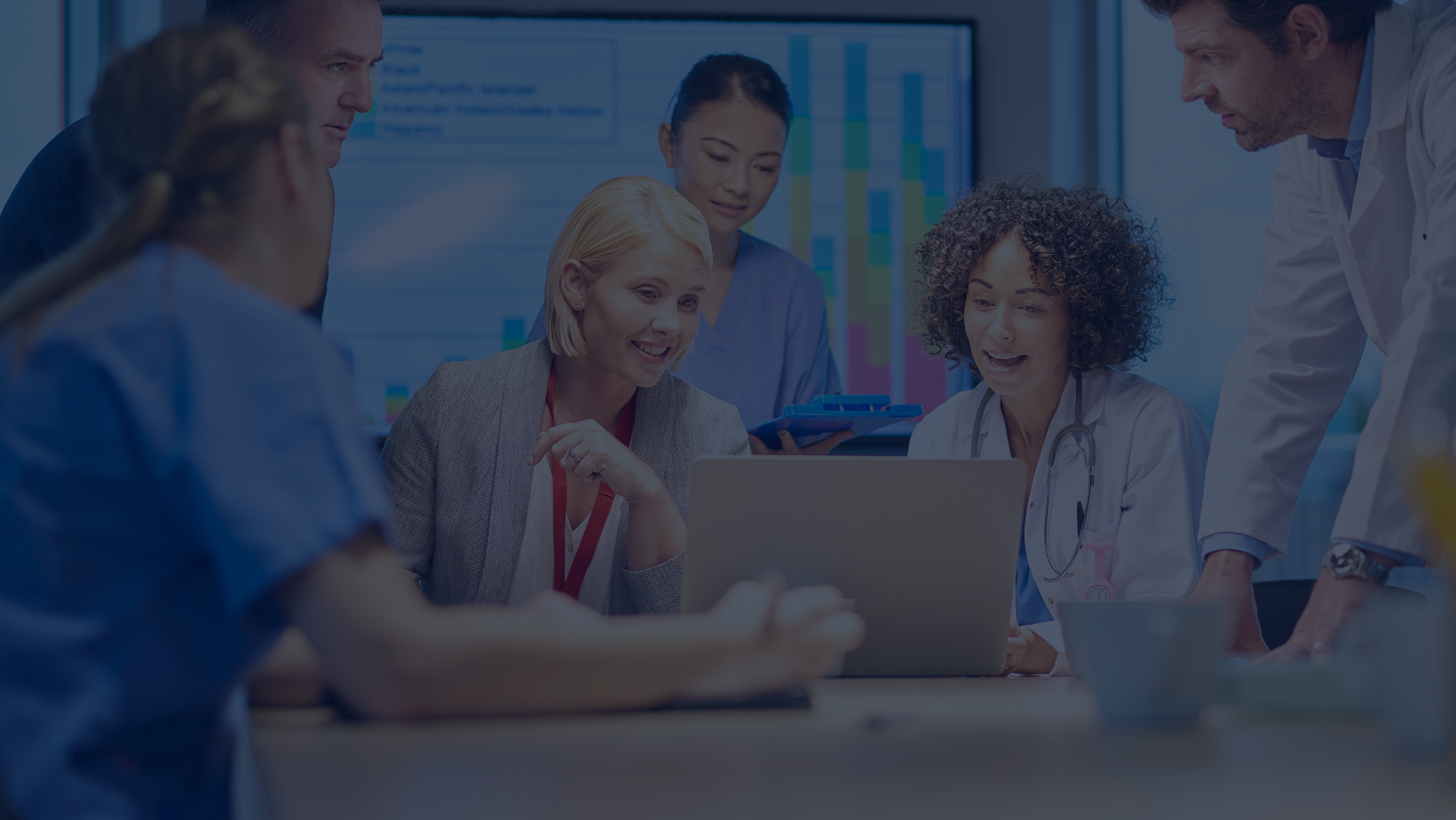 Healthcare team around laptop